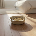 Beige puzzle feeder bowl for pets with smaller color variants displayed below on a white background.