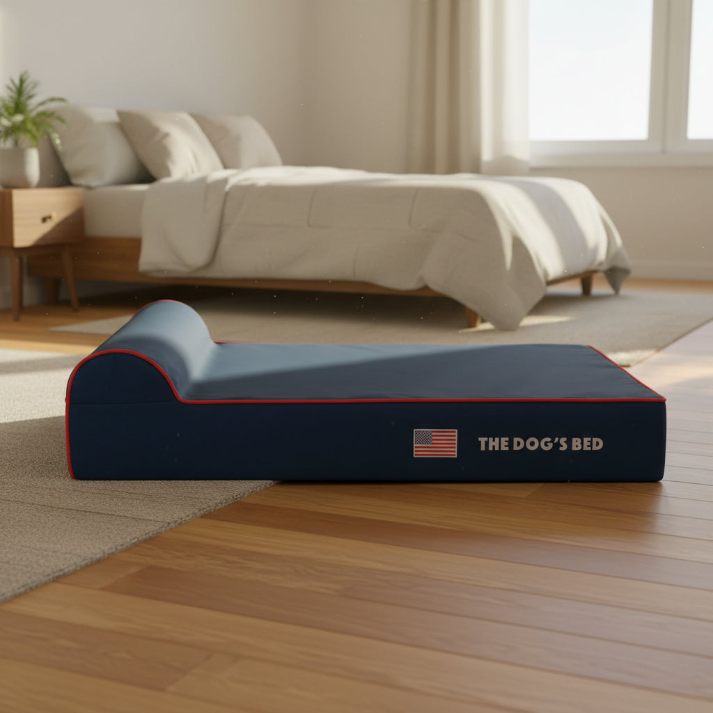 Blue pet bed with red trim and 'The Dog's Bed' branding on a white background